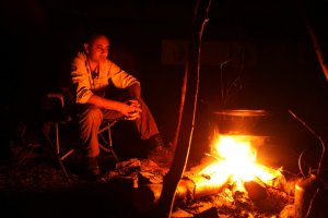 Manse sat around fire at night.jpg